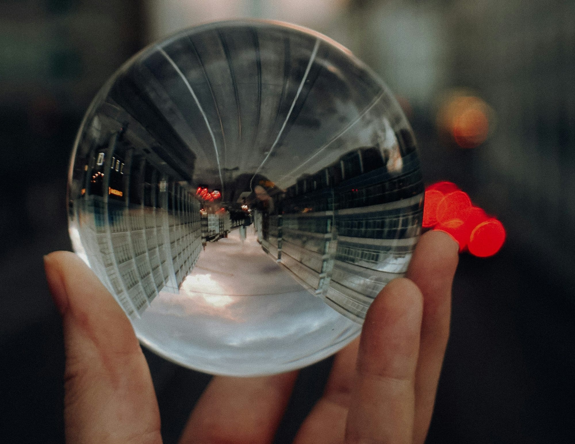 person holding clear glass ball