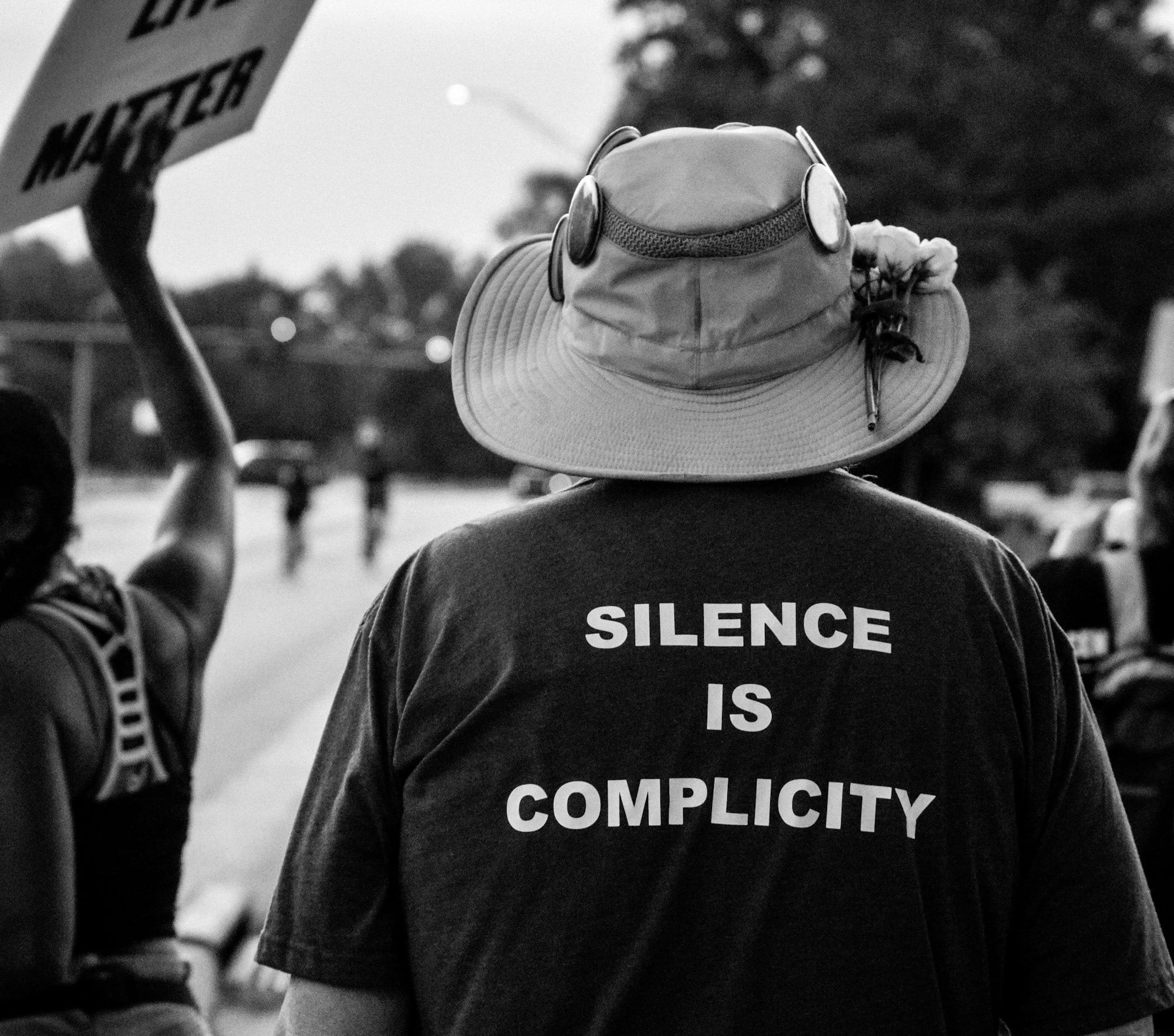 grayscale photo of man wearing hat and t-shirt
